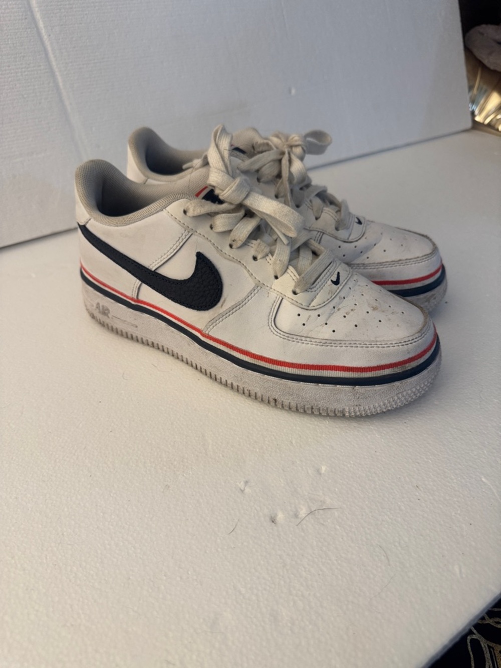 Nike White Low-Top Sneakers with Black Swoosh and Red & Blue Trim